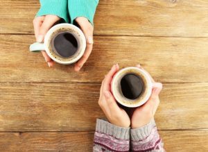 holding coffee cups